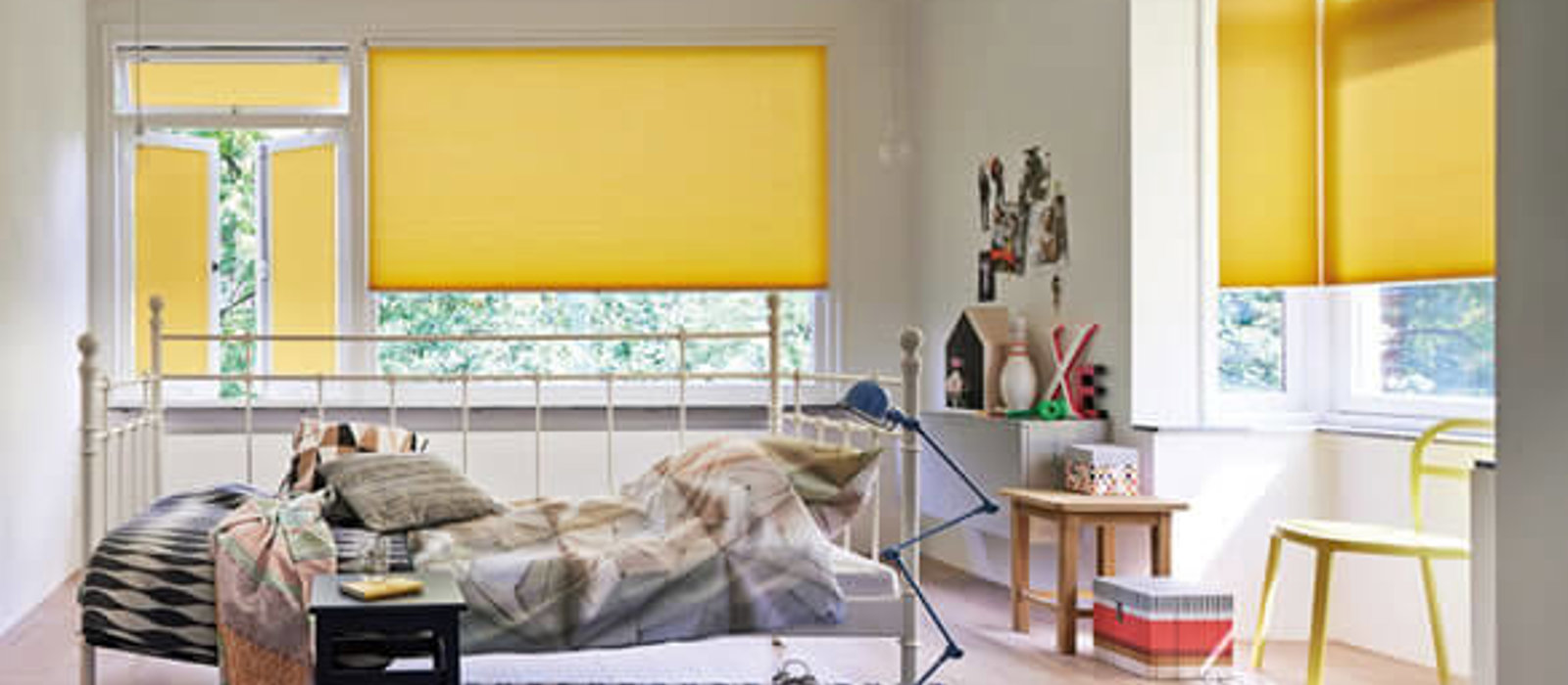 Bedroom with colourful yellow Duette energy-saving blinds