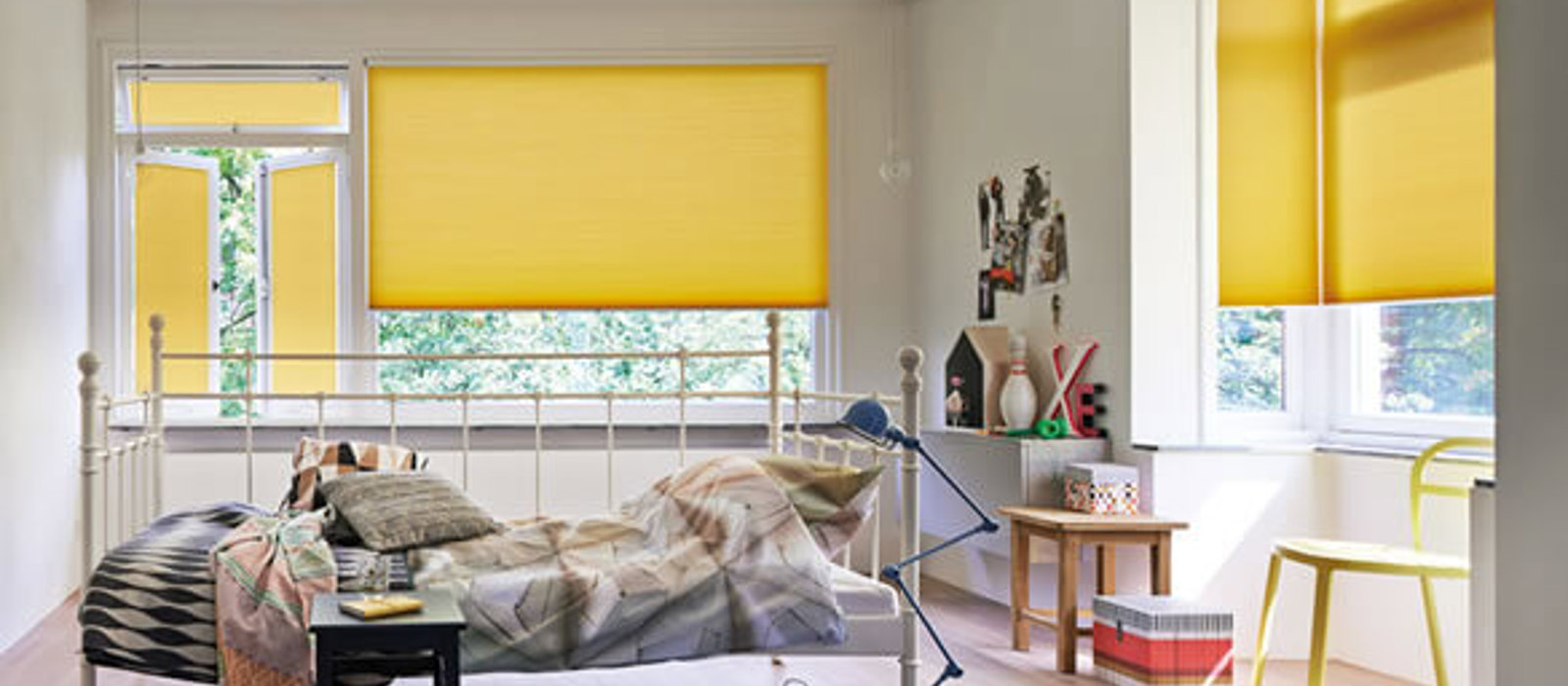 Child's bedroom with yellow Duette energy saving blinds for sustainability