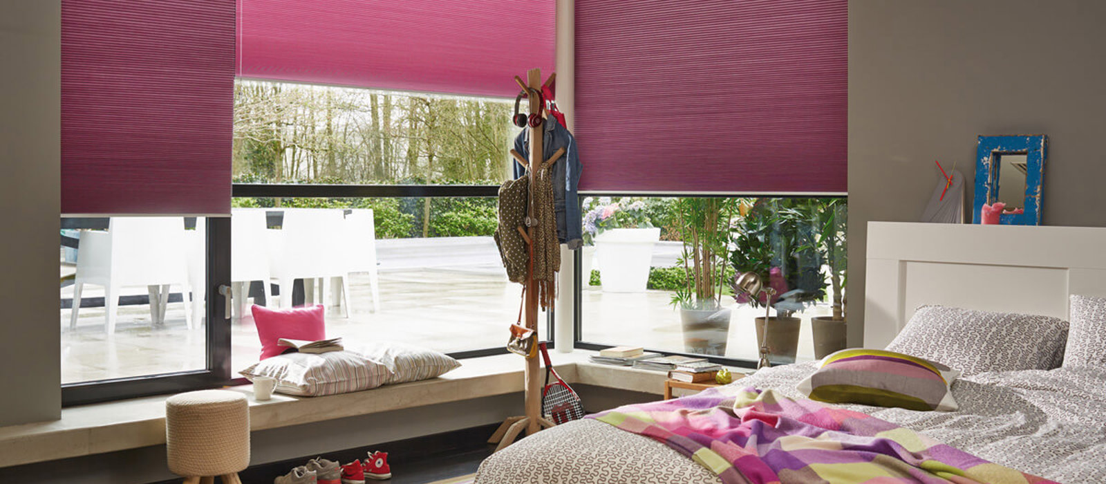 Colourful child's bedroom with hot pink Duette energy-saving blinds