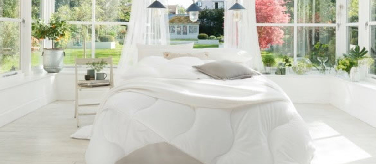White minimalist bedroom with large windows