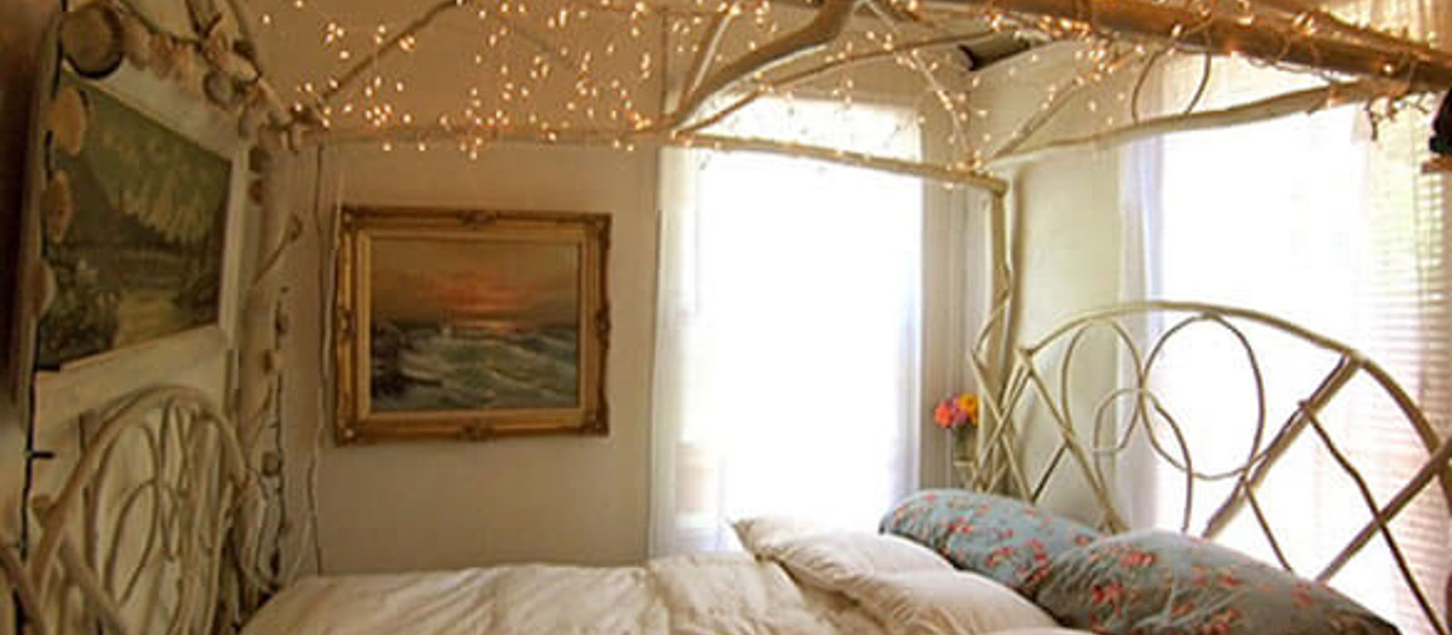 Cosy bedroom with fairylights canopy and Duette blinds for light control