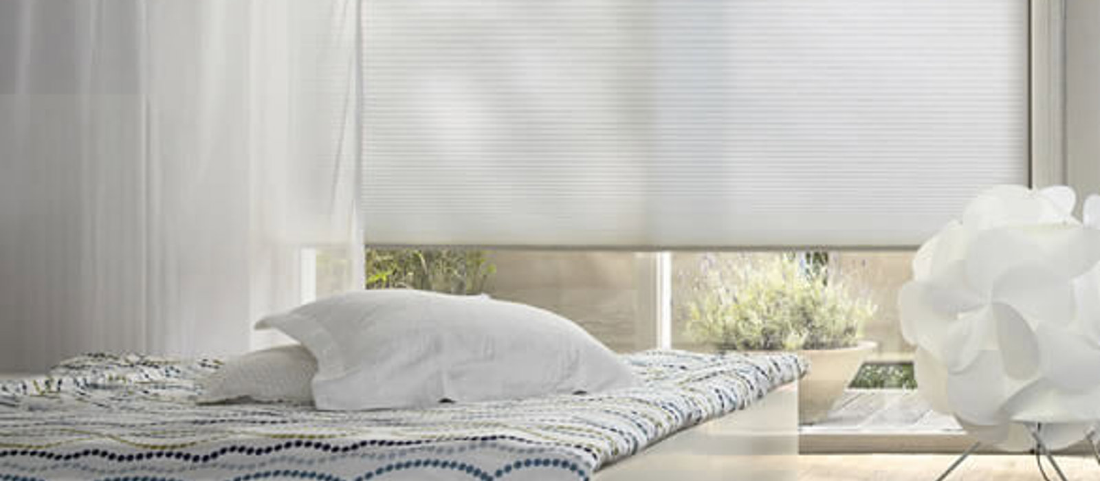 White minimalist bedroom with Duette energy-saving blinds