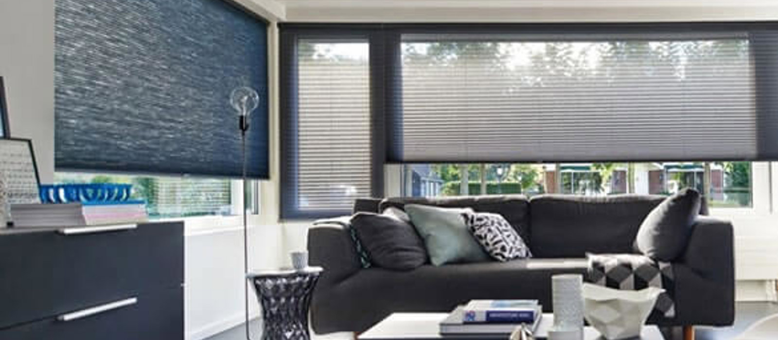 Modern living room with windows fitted with Duette recycled fabric blinds