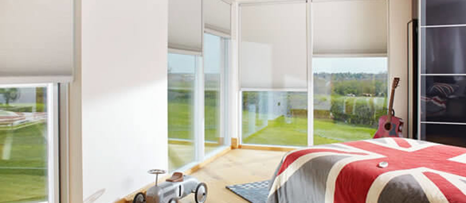 Modern child's bedroom with large windows fitted with Duette energy saving blinds